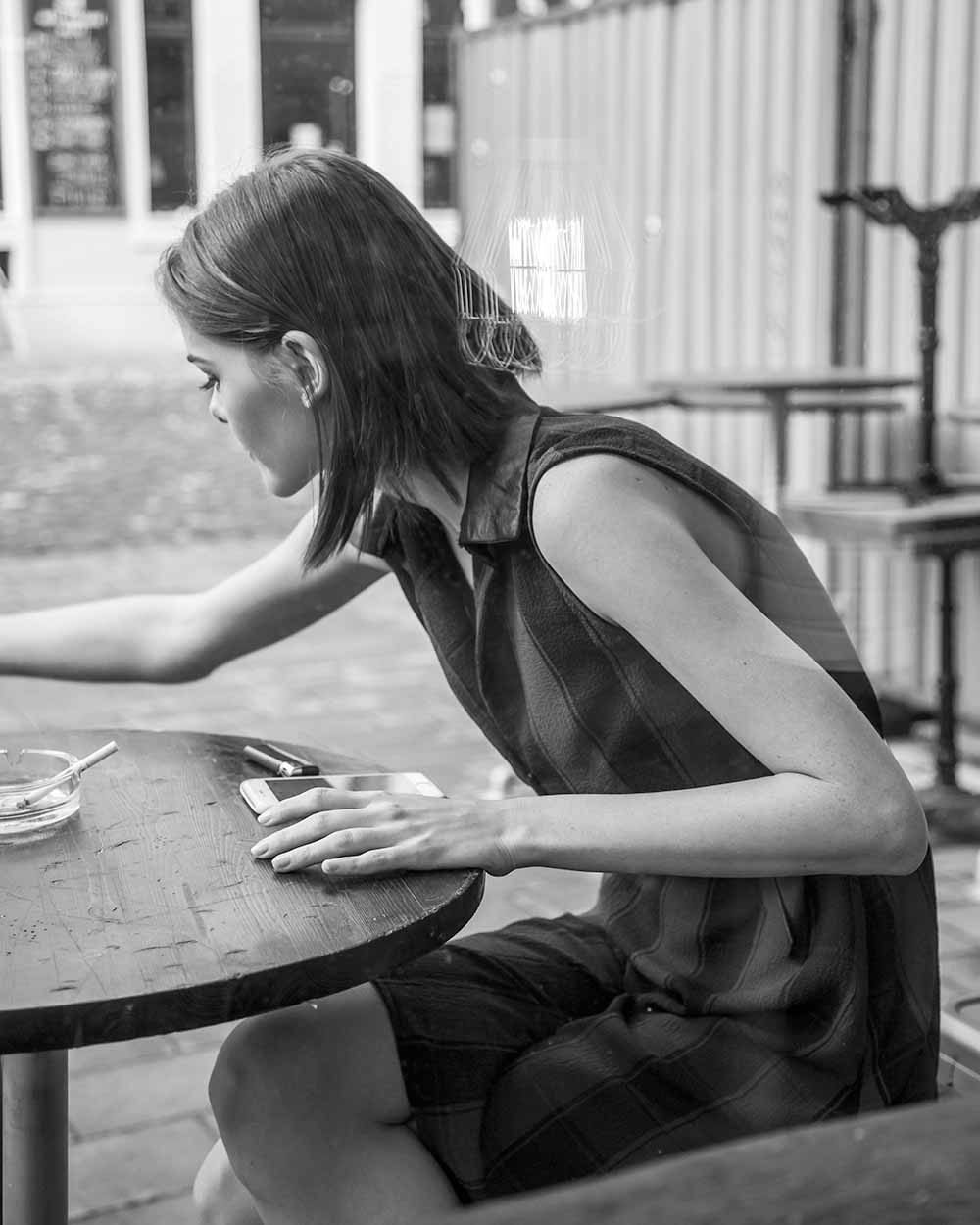 girl sitting at ttable black and white