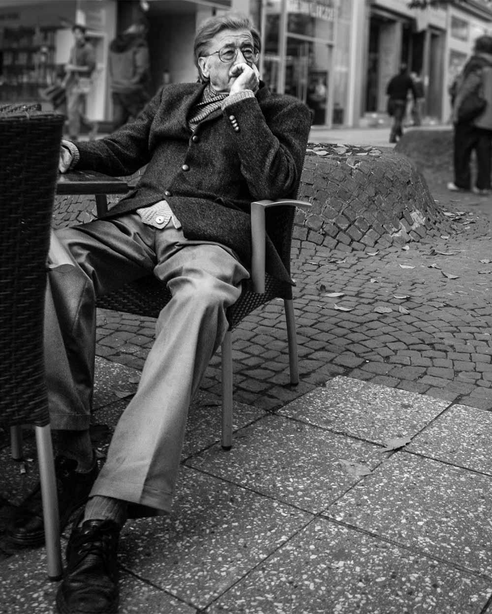 old man at table black and white