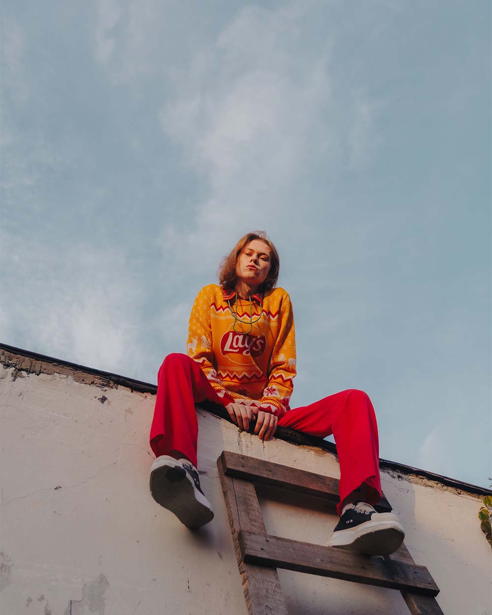 girl sitting on roof with vibrant clothes